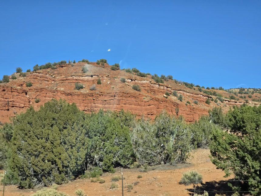 Red sandstone bluff above juniper and pinyon